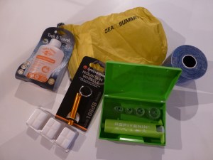 Clockwise from upper left: Hand Sanitizer, Ultralight Packing Bag, Kinesio Tape, Aspivenin anti-venom pump, Mountain Whistle for emergencies and alcohol tablets for our stove.