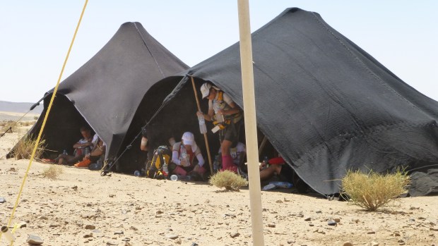 Finding shade for a few moments in the berbertents at a checkpoint.